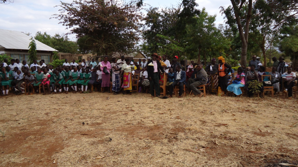 Parents, pupils and community looking on during harambee