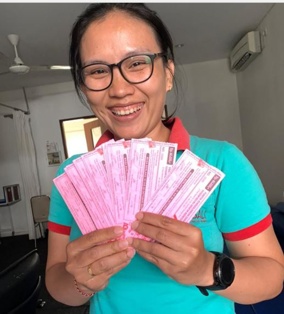 A happy supporter with her coupons